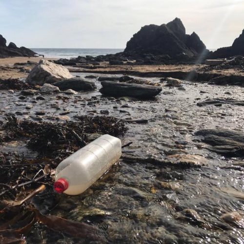 ocean plastic on beautiful beach