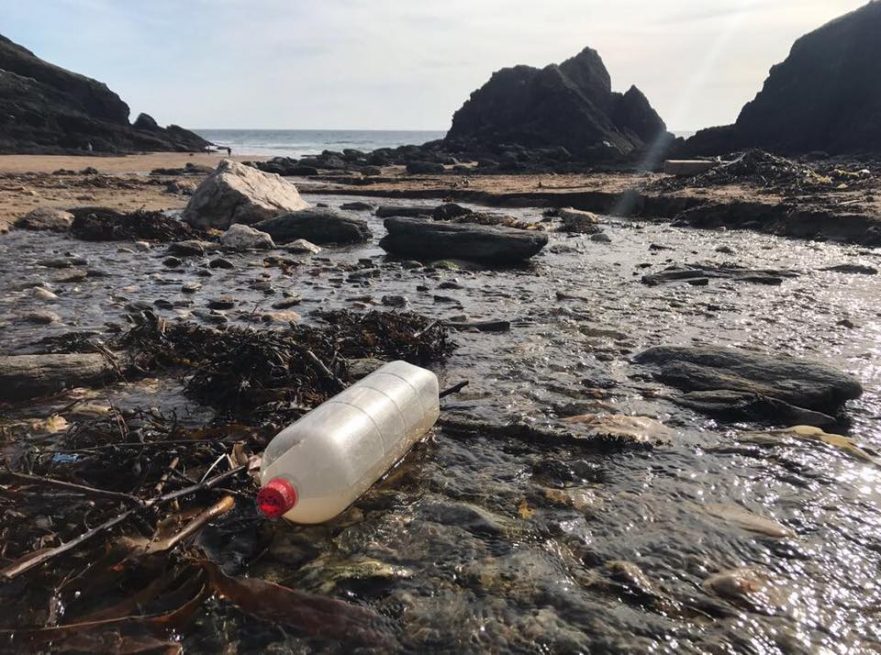 ocean plastic on beautiful beach